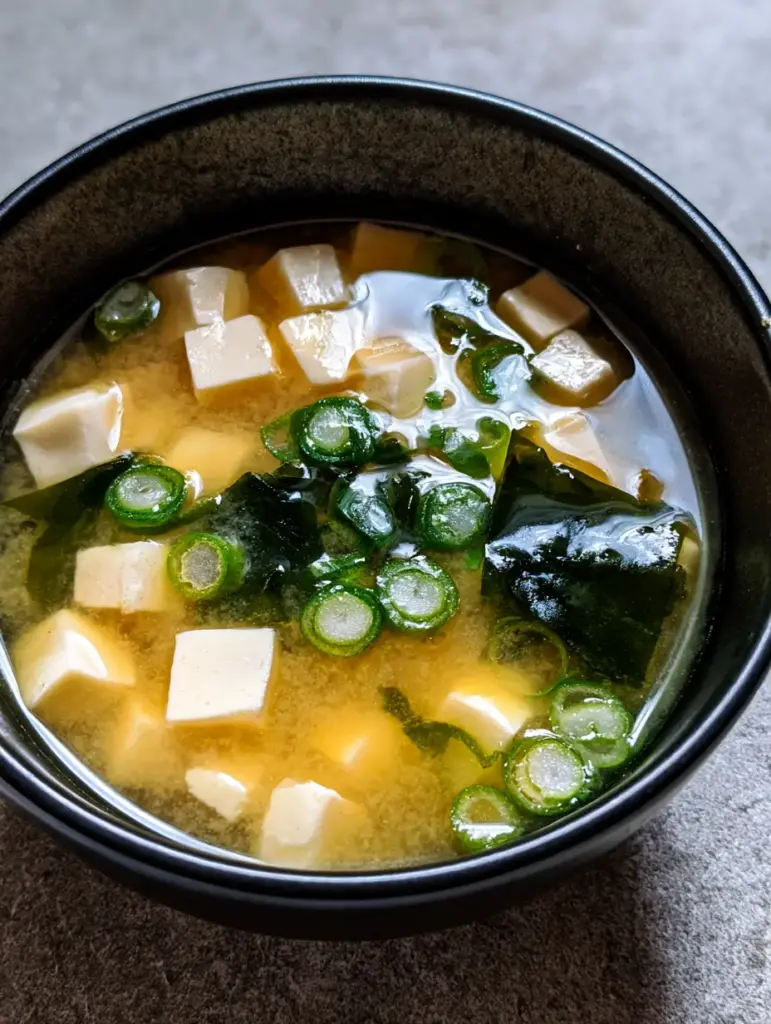 Easy Miso Soup Recipe: The Ultimate 15-Minute Japanese Comfort Bowl 1 Close-up of silken tofu cubes and wakame seaweed in an Easy Miso Soup Recipe.